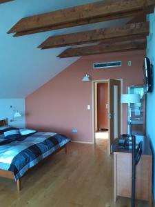 a bedroom with a bed and a wooden floor at Apartmány Puerto in Senec