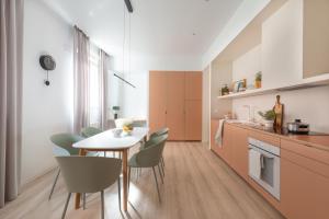 a kitchen and dining room with a table and chairs at Bilbao Park by Aston Rentals in Bilbao