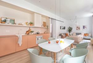 een keuken en een woonkamer met een witte tafel en stoelen bij Bilbao Park by Aston Rentals in Bilbao