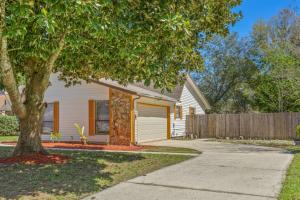 a house with a tree and a fence at Blue Heron in Jacksonville