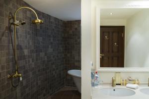 a bathroom with a sink, toilet and bathtub at Bogatyr Hotel in Adler