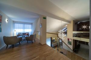 a living room with a couch and a table and chairs at Natura Villa Spa in Węgrzce