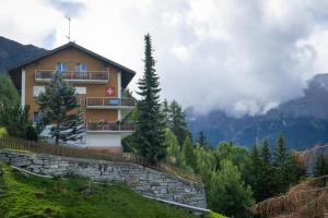 a house on the side of a hill with mountains at Panorama at Haus Waldheim Nr. 11 in Grächen