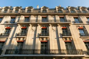a tall building with balconies on the side of it at La Clef Champs-Élysées Paris by The Crest Collection in Paris