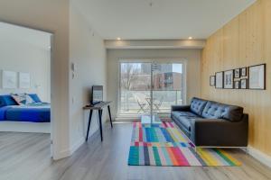 a living room with a couch and a bed at The Halo by BnbCopilote in Quebec City