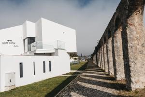 a view of the wall of a building at Obidos Aquae Ductus Suites in Óbidos