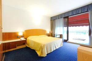 Postel nebo postele na pokoji v ubytování Eurocongressi Hotel