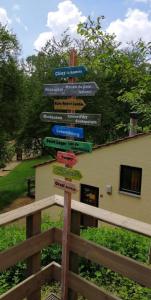 een straatbord met veel verschillende borden erop bij Le jardin d'Eugénie gîte a Virton en pleine nature in Virton