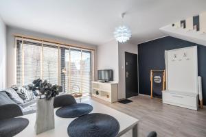 a living room with a couch and a table at Apartamenty Hallerowo in Władysławowo