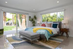 a bedroom with a bed and a large window at Villa Perfetto Plaza in Palm Springs +54 photos