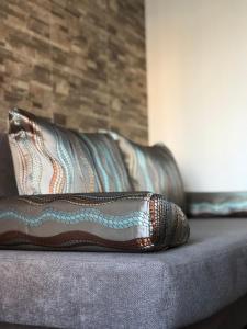 a pillow sitting on top of a couch at Квартира с двумя комнатами в Ж/К Атлант (ул. Антоновича 36Д) in Dnipro