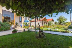 a bike parked in the grass in front of a house at Sweet Alvani in Akhmety