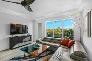 a living room with a couch and a large window at Cape Crossing Resort & Marina in Merritt Island