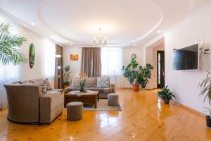 a living room with a couch and a table at Sweet Alvani in Akhmety