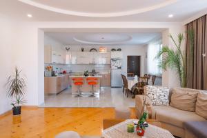 a living room and kitchen with a couch and a table at Sweet Alvani in Akhmety