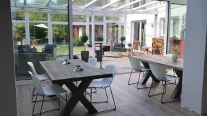 a patio with a wooden table and chairs at Stadtvilla Intzeplatz - Apartment Rügen in Remscheid