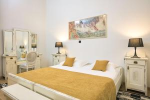 a bedroom with a bed and a painting on the wall at Palmotta Palace in Dubrovnik