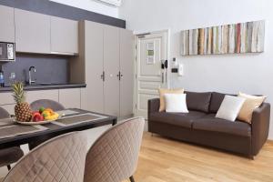 a kitchen and a living room with a couch and a table at Palmotta Palace in Dubrovnik
