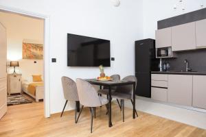 a kitchen and dining room with a table and chairs at Palmotta Palace in Dubrovnik