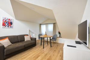 a living room with a couch and a table at Palmotta Palace in Dubrovnik