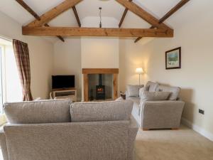 a living room with two couches and a tv at Horsley Cottage in Consett