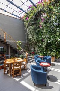 a patio with tables and chairs and flowers at Arawi Hotel Boutique in Valle de Bravo