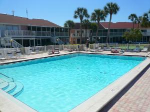 a large swimming pool in front of a hotel at TWO Bedroom TWO Bath Family Condo - Sleeps Four - Unit B - Private Beach in St. Petersburg