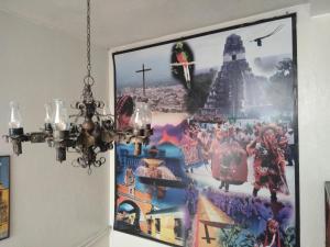 a picture hanging on a wall with a chandelier at Hotel Metropolitano in Guatemala