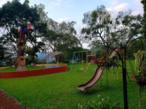 a park with a slide and a playground at Hotel Hacienda Prom in Misantla