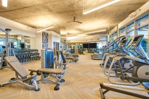 a gym with a lot of treadmills and machines at Sonder at McKinley in Phoenix