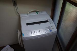 a fax machine sitting on top of a washing machine at Moon's Cafe in Onomichi