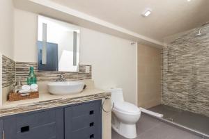 a bathroom with a sink and a toilet and a mirror at Arawi Hotel Boutique in Valle de Bravo +72 photos