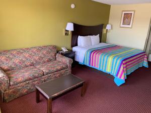 a hotel room with a couch and a bed at Western Motel - Prentiss in Prentiss