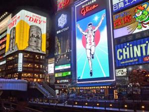 a group of buildings with signs on them at APA Hotel Shin Osaka Ekimae in Osaka