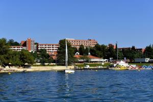 a large body of water with boats in a city at Hotel Albatros Plava Laguna in Poreč