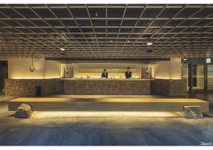 two men standing at a bar in a building at ORIENTAL HOTEL KYOTO ROKUJO in Kyoto