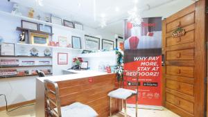a shop with a sign that says why pay more than stay at red room at RedDoorz at DBuilders Rooms Ph1 Taguig in Manila