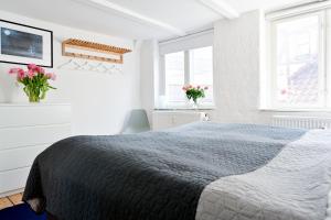 コペンハーゲンにあるSanders Penny - Lovely Two-Bedroom Apartment in the Middle of Actionの白いベッドルーム(ベッド1台、窓2つ付)