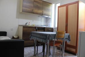 a kitchen with a table and chairs in a kitchen at Dove Apart Hotel in Fethiye