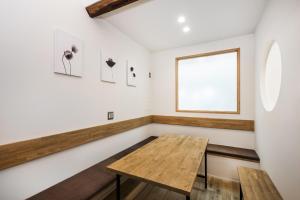 a room with a wooden table and a window at Japan Sessions KANZAKI 01 in Osaka