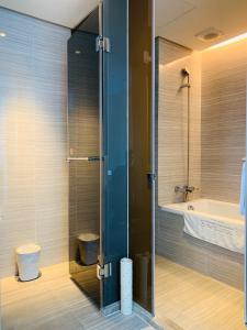 a bathroom with a shower, toilet and sink at City Suites - Kaohsiung Chenai in Kaohsiung