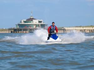 a man riding a jet ski in the water at Hotel Paradisio by WP Hotels in Blankenberge