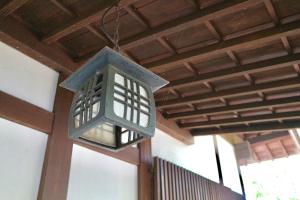 a lantern hanging from the ceiling of a building at Bunanoyado Koase in Aga