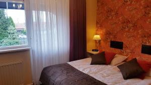 Een bed of bedden in een kamer bij De Vier Seizoenen