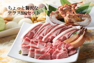 a plate of meat and other foods on a table at Resort Villa Takayama in Takayama