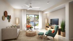 a living room with a couch and a tv at Domaine de Grand Baie in Grand-Baie