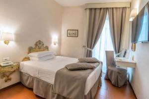En eller flere senger på et rom på Hotel Machiavelli Palace