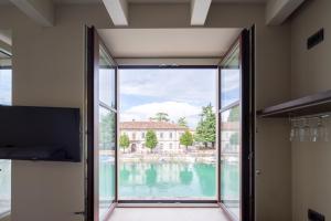 an open door with a view of the water from a house at CABANON urban apartments in Peschiera del Garda