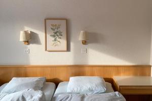 a hotel room with two beds and a table and two lamps at La Civetta (714 La) in Valbella +32 photos