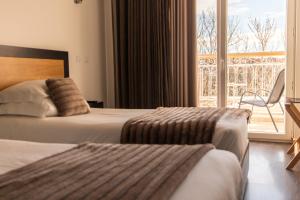 Een bed of bedden in een kamer bij Hotel Muchacho